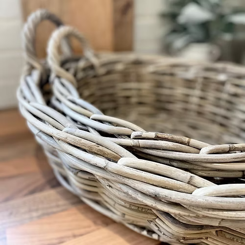 Natural tone rattan basket, perfect for carrying tableware or as a decorative centrepiece in any neutral interior.