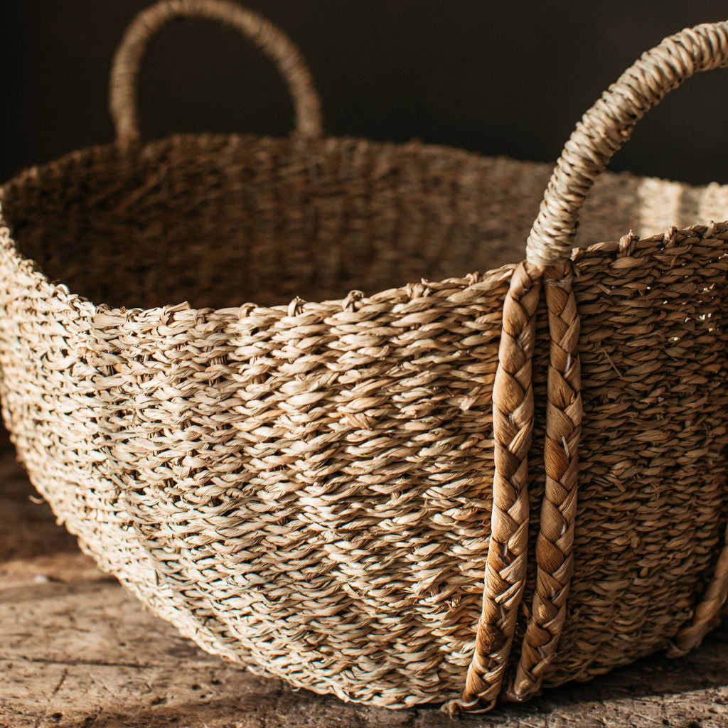 Natural seagrass storage basket with braided handles, adding a warm, textured touch to your home while keeping spaces organised.
