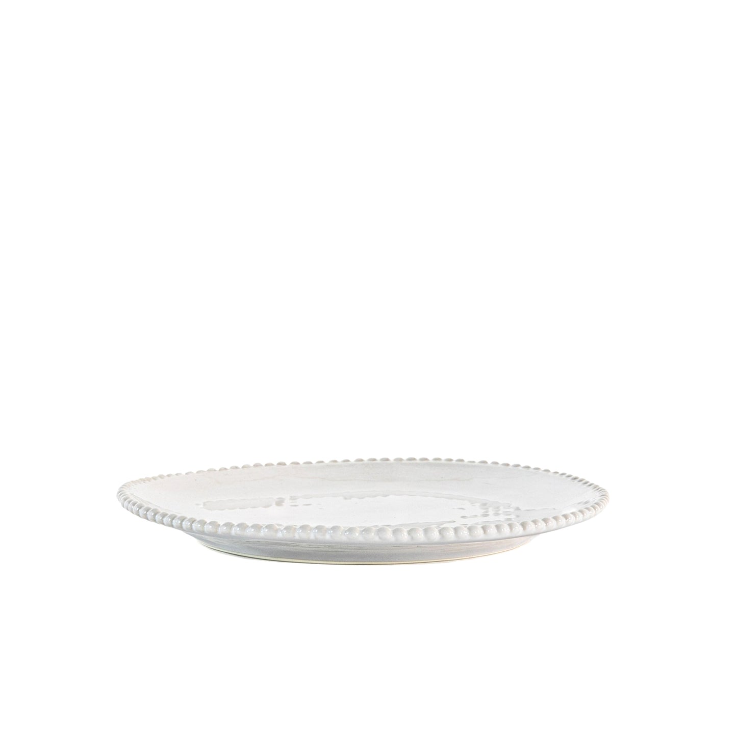 White porcelain side plate with organic shape and beaded detailing around the rim. Styled in front of white background.
