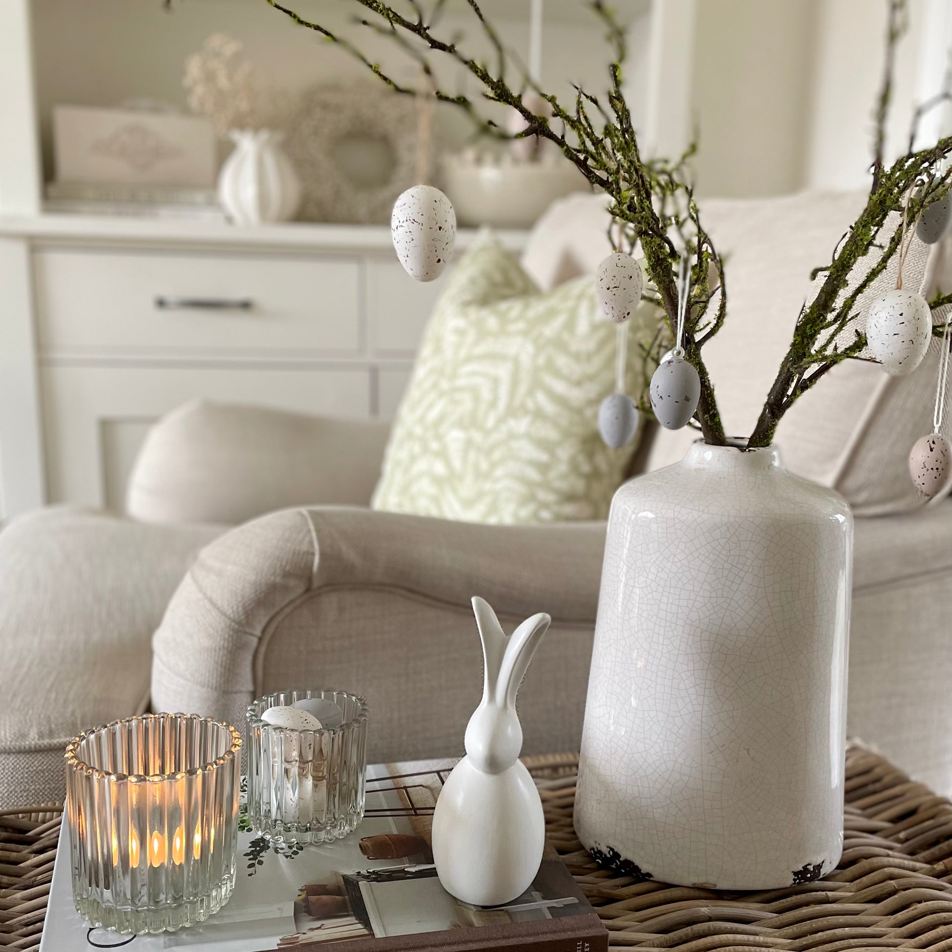 Porcelain sitting bunny for Spring and Easter decor. Styled with eggs and candle.