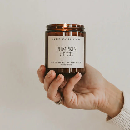 Pumpkin spice candle in amber glass jar. Scents of pumpkin, cloves, cinnamon and vanilla.