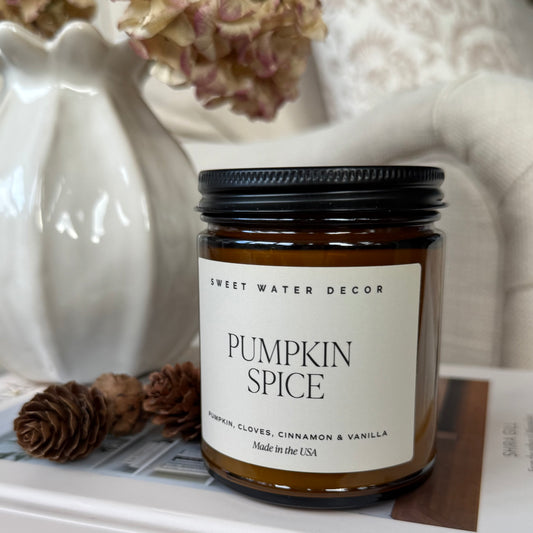 Pumpkin spice candle in amber glass jar. Scents of pumpkin, cloves, cinnamon and vanilla.