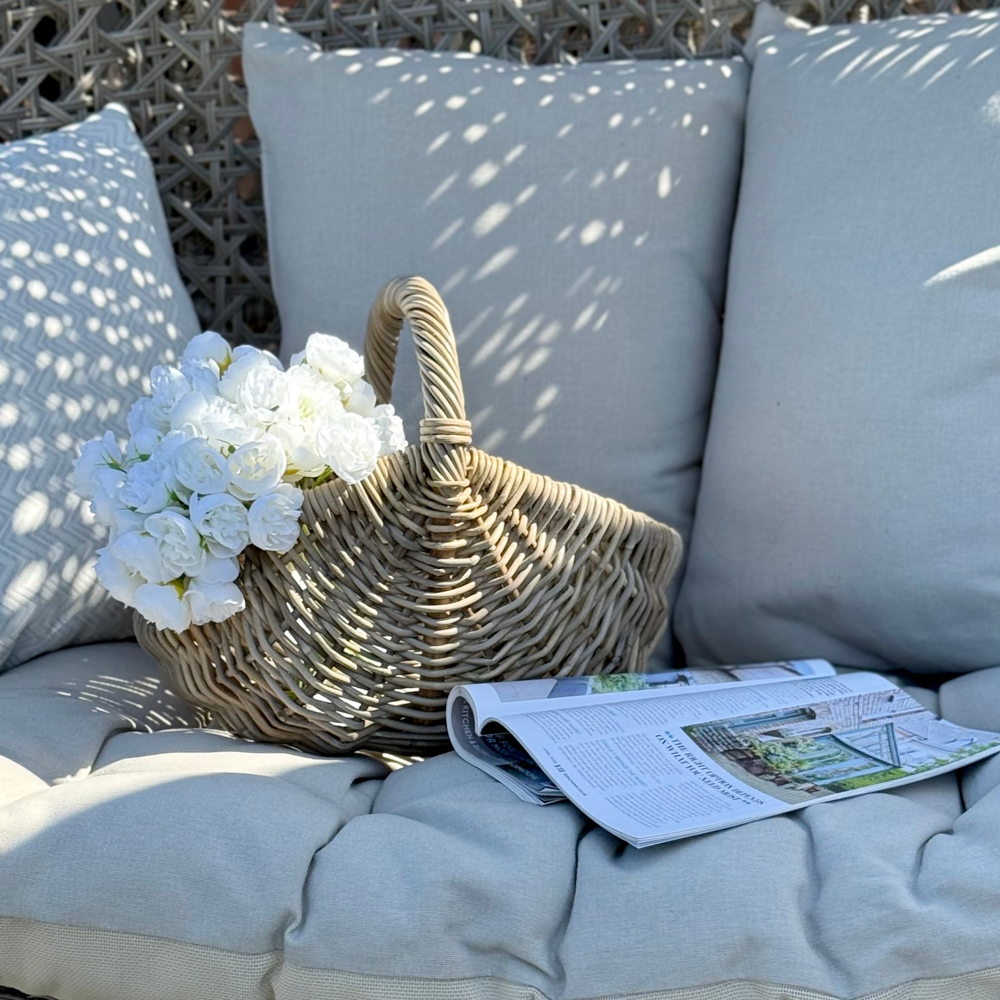 Handwoven rattan basket with circular handle, perfect for flowers, kindling or home storage. Perfect for country style living.