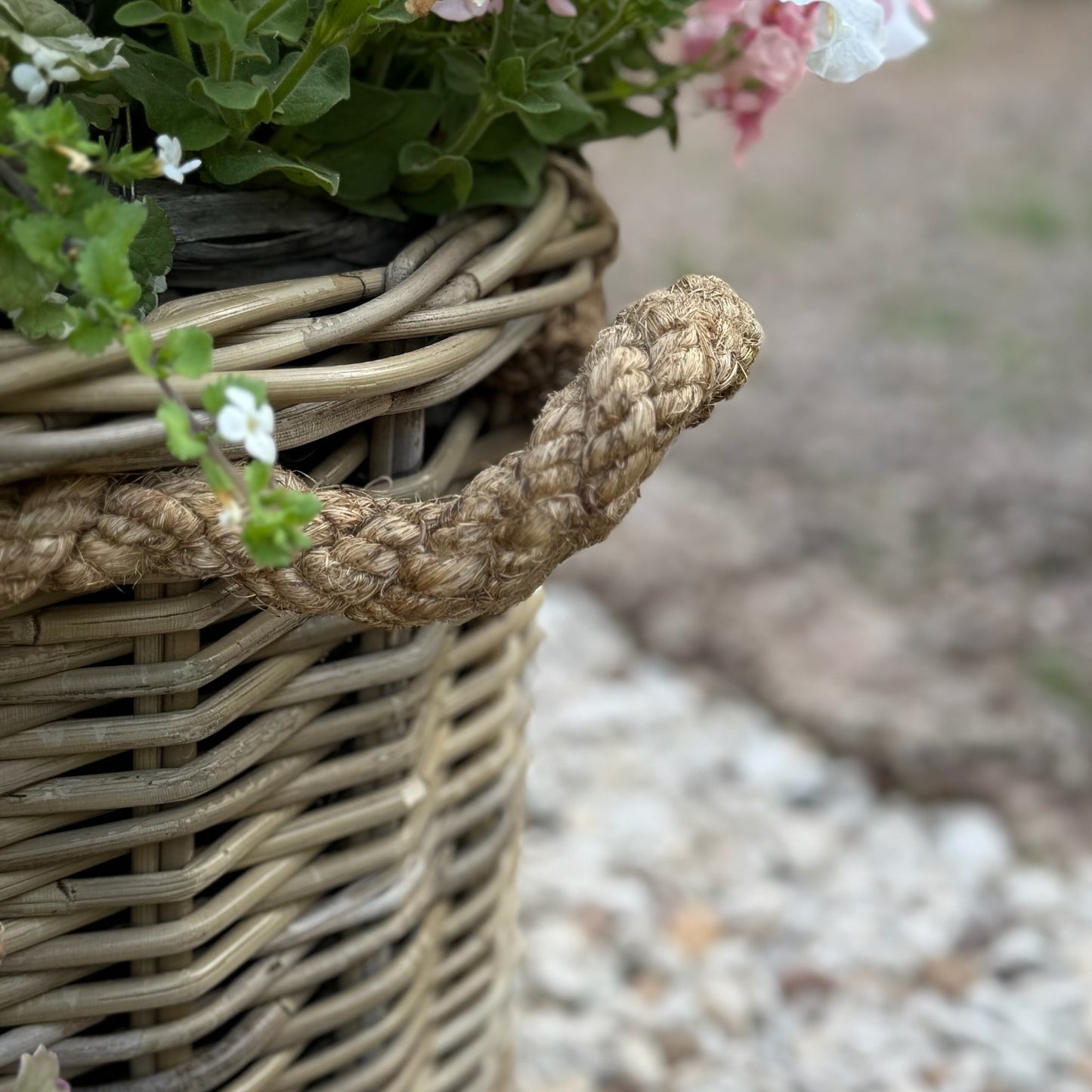 Handcrafted rattan planter with hidden plastic liner, perfect for front doors, patios, or garden corners.