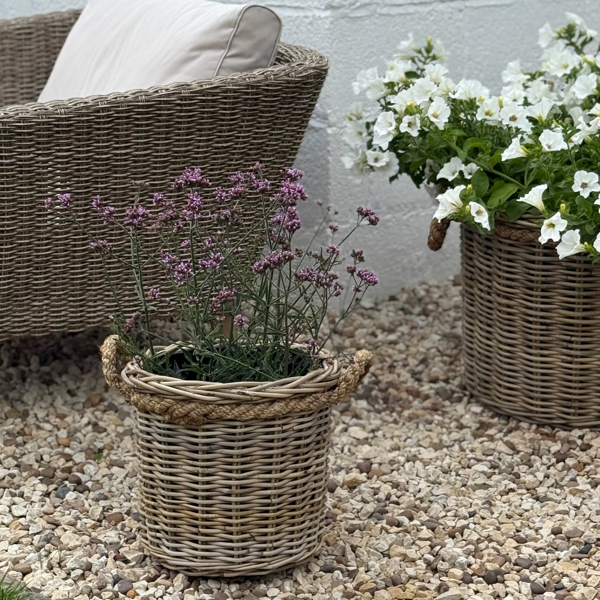 Handcrafted rattan planter with hidden plastic liner, perfect for front doors, patios, or garden corners.