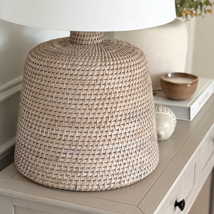 Handwoven rattan table lamp with whitewashed finish, available with or without shade.
