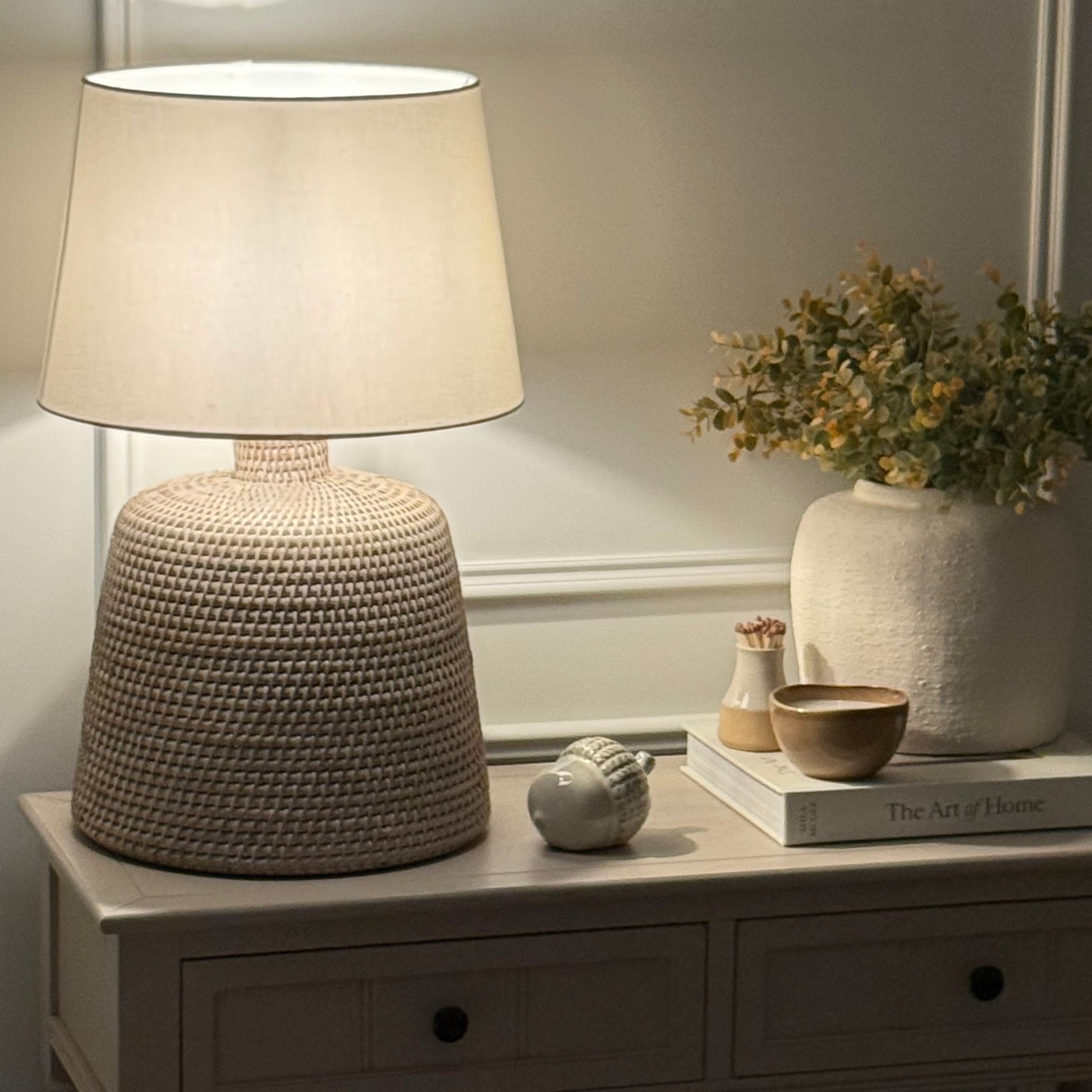 Handwoven rattan table lamp with whitewashed finish, available with or without shade