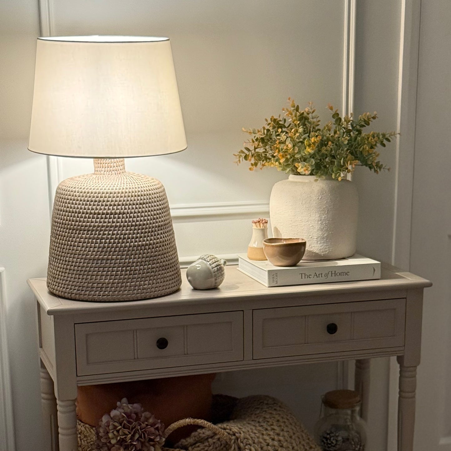 Handwoven rattan table lamp with whitewashed finish, available with or without shade.