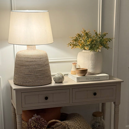 Handwoven rattan table lamp with whitewashed finish, available with or without shade.
