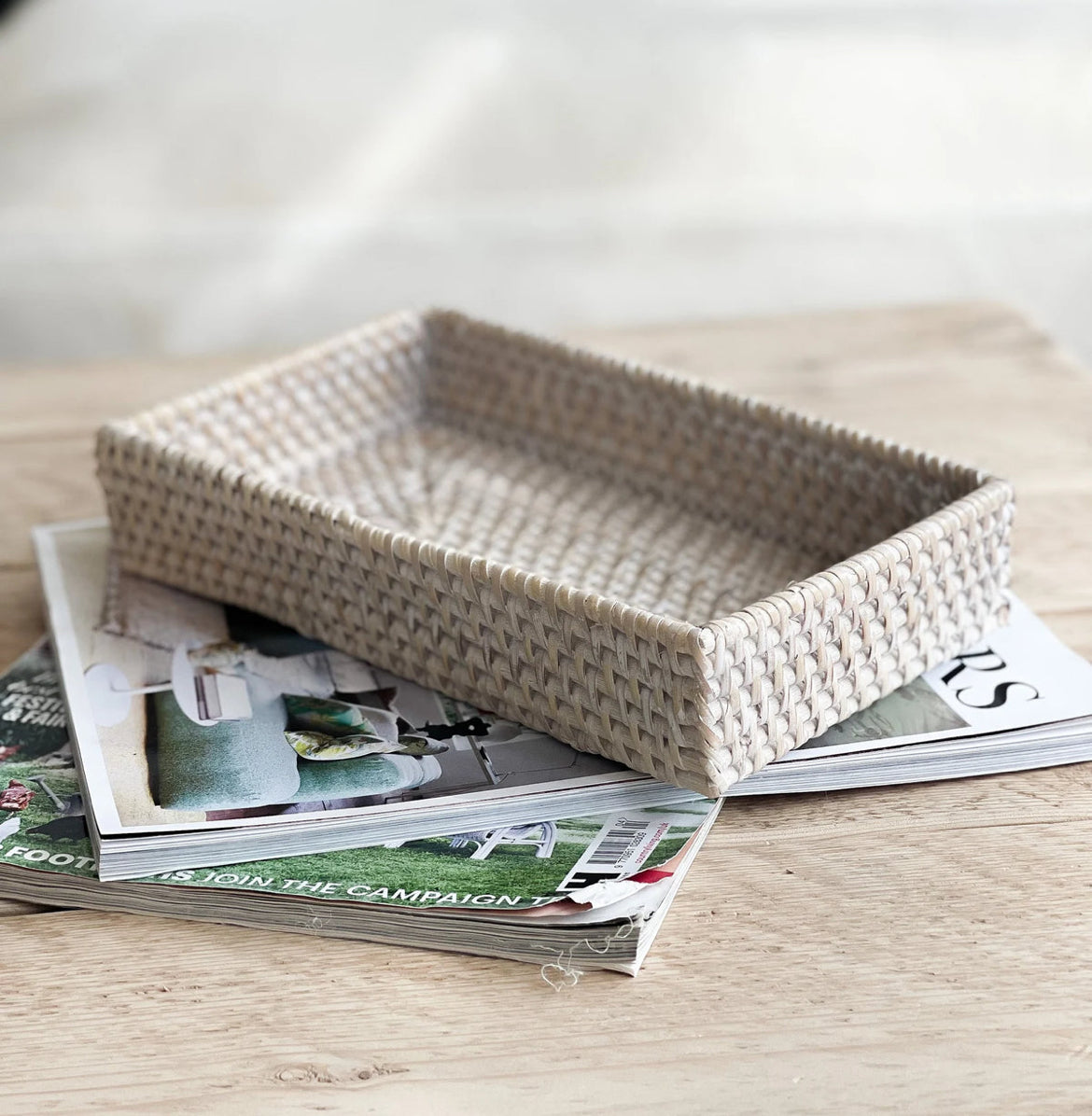 Natural woven rattan tray with rustic charm. Styled on a coffee table.