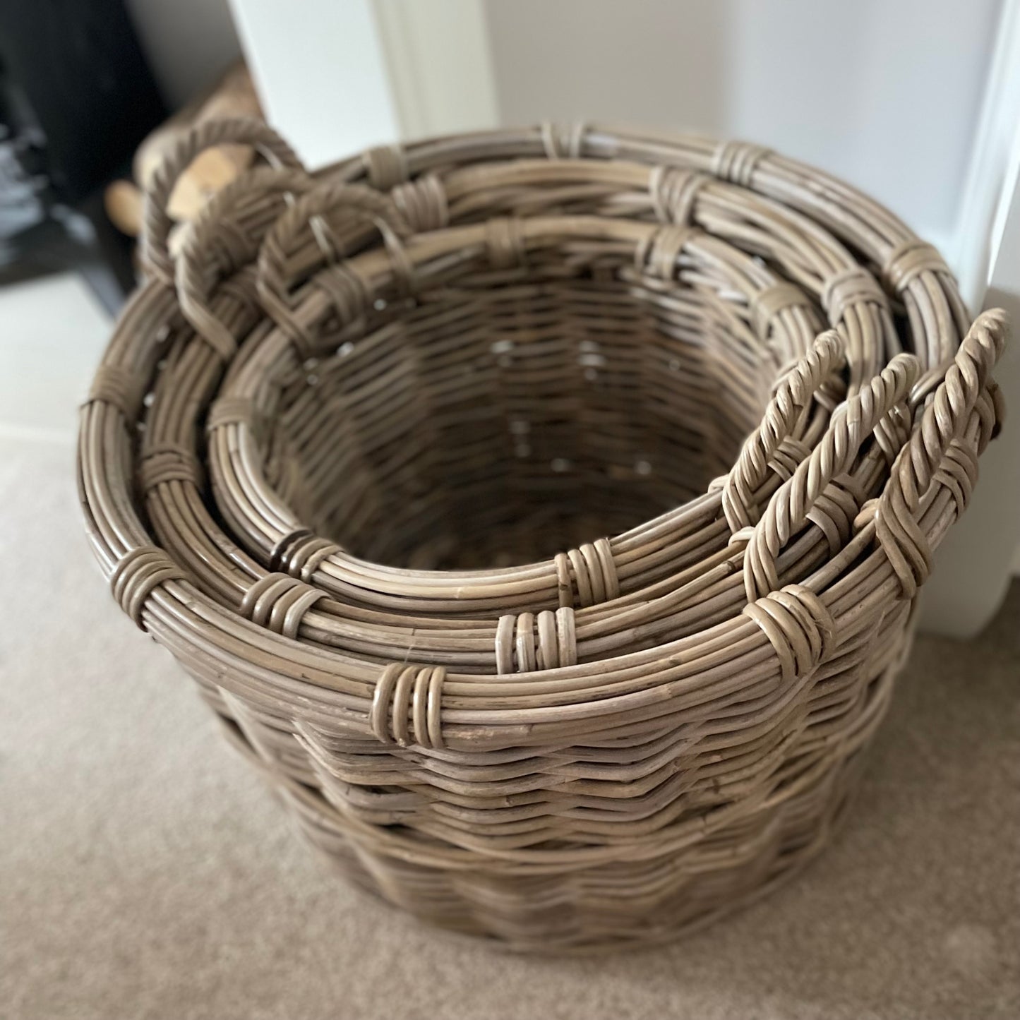 High quality handwoven rattan basket storing everyday items, adding texture and warmth to a living room.