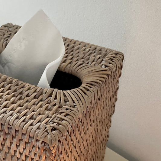 Close up of whitewashed rattan weave on square tissue box cover.