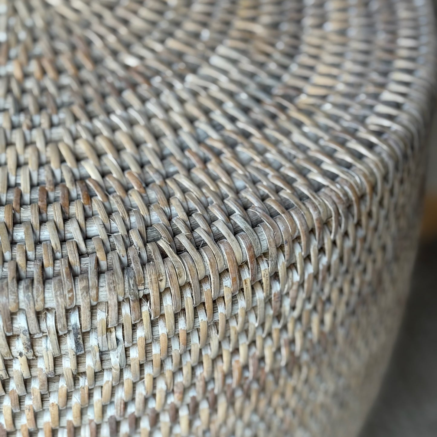 Natural textured rattan stool, versatile as extra seating, side table, or decorative accent in a cozy home corner.