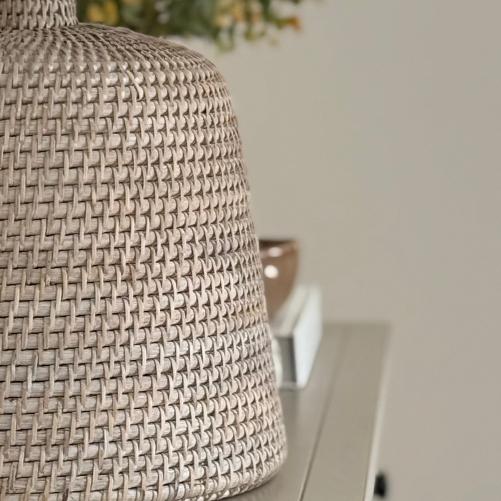 Handwoven rattan table lamp with whitewashed finish, available with or without shade.