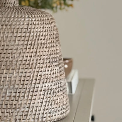 Handwoven rattan table lamp with whitewashed finish, available with or without shade.