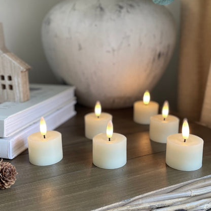Set of realistic flameless tea lights creating a warm ambient glow.
