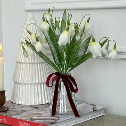 Realistic frosted snowdrop stem with delicate white blooms and soft frosted detail. Perfect for elegant winter home decor styling.
