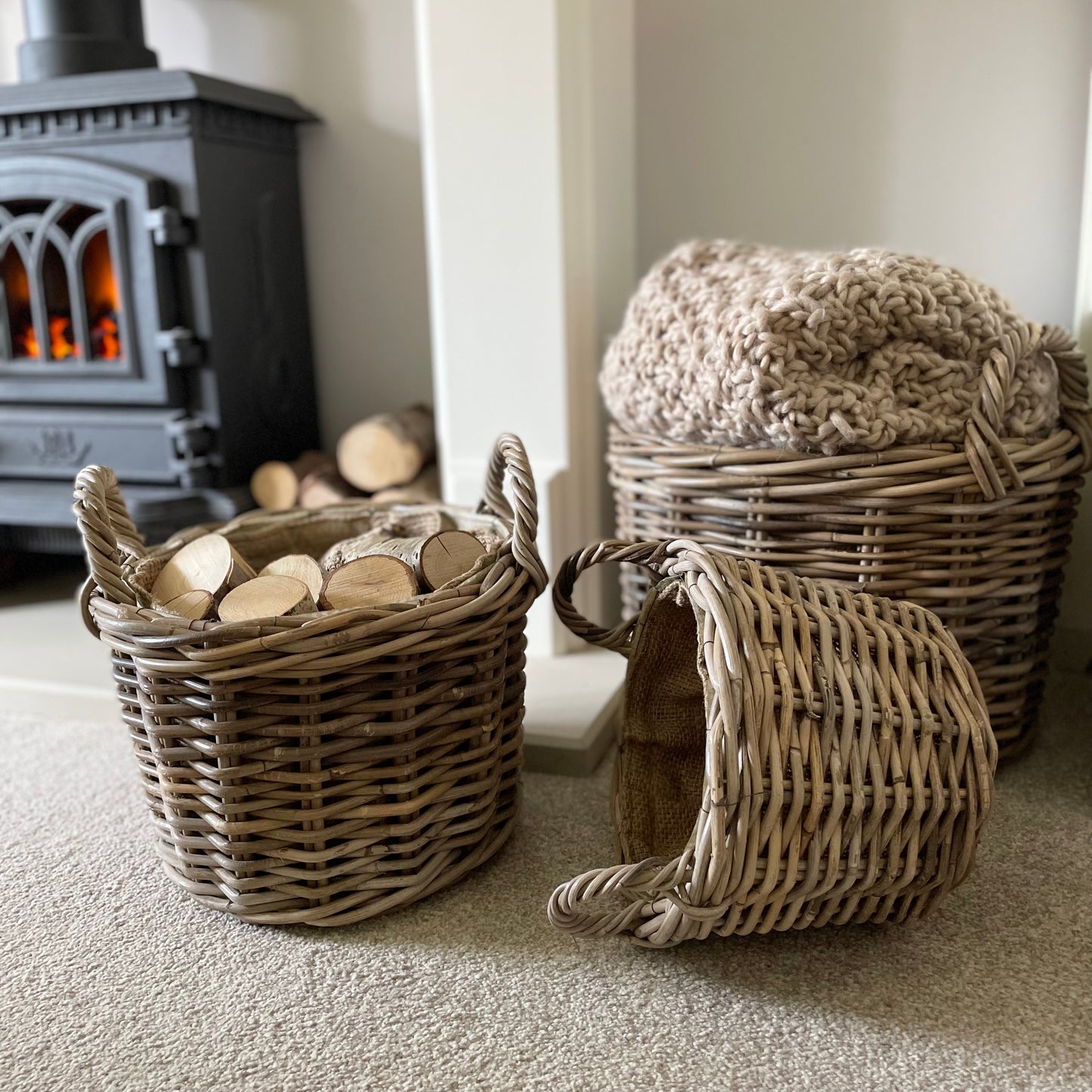 Round rattan basket with ear handles and removable hessian liner, perfect for storing throws or firewood.