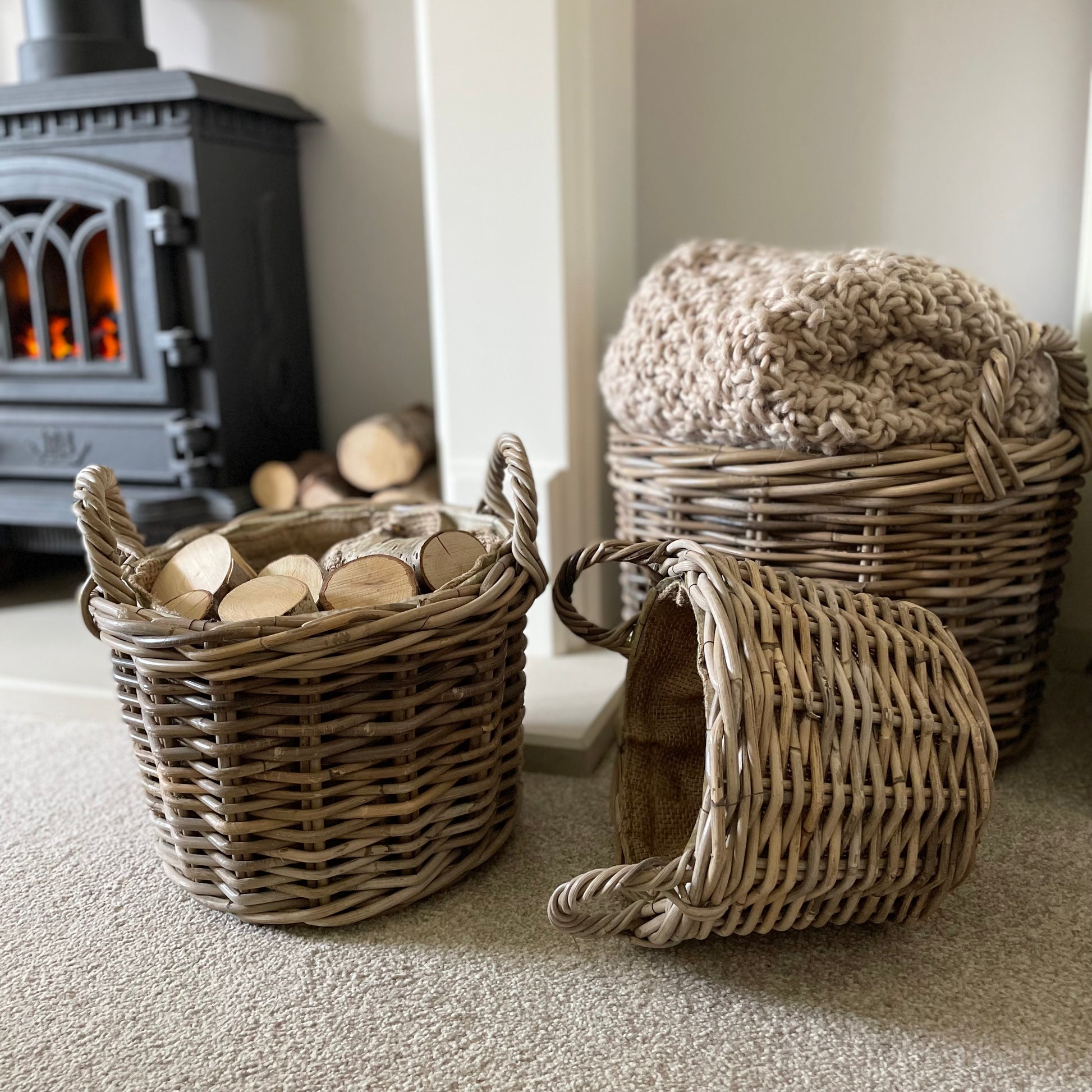 Round rattan basket with ear handles and removable hessian liner, perfect for storing throws or firewood.