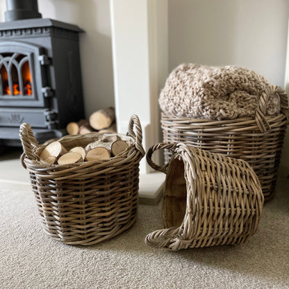 Round rattan basket with ear handles and removable hessian liner, perfect for storing throws or firewood.
