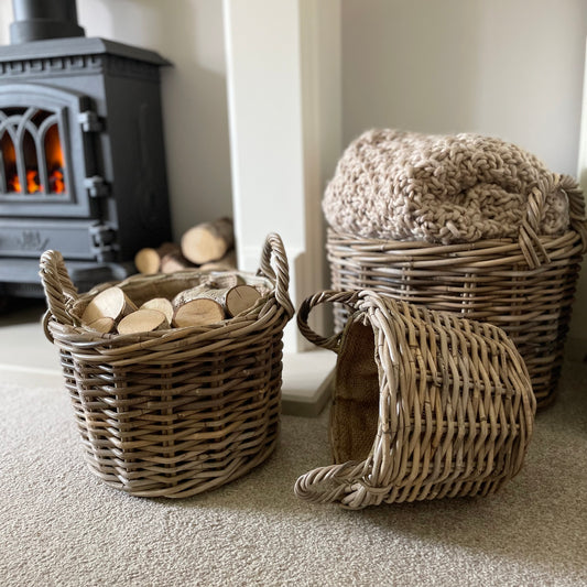 Round rattan basket with ear handles and removable hessian liner, perfect for storing throws or firewood.