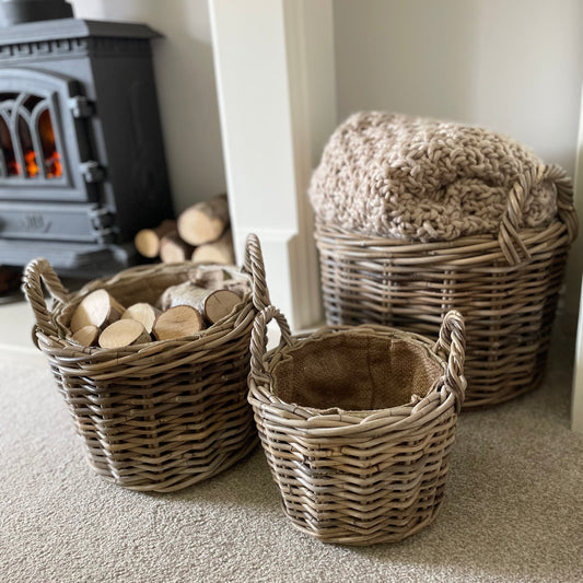 Round rattan basket with ear handles and removable hessian liner, perfect for storing throws or firewood.