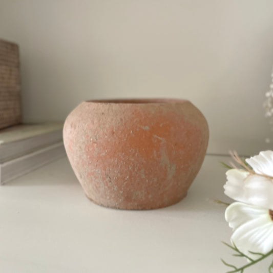 Light terracotta plant pot with rustic texture. Styled on a shelf with a cosmos spray.