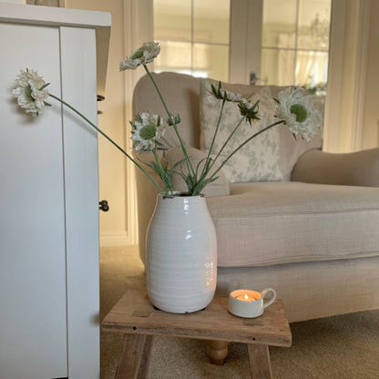 Faux Scabiosa Stem with off white flowers and soft green centres, styled in a neutral glazed vase
