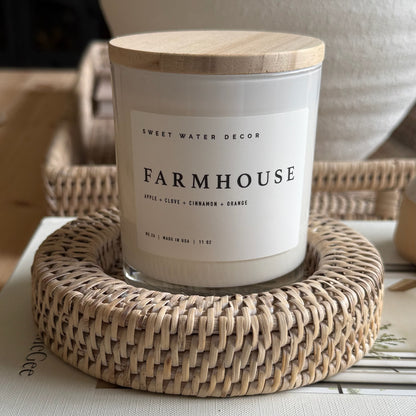 Farmhouse candle in rustic glass jar surrounded by autumnal accents, evoking warm notes of apple, cinnamon, and vanilla.