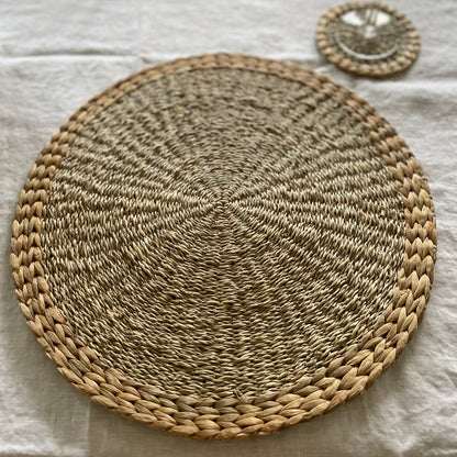 Handmade seagrass and water hyacinth placemats. Styled on a white linen tablecloth.