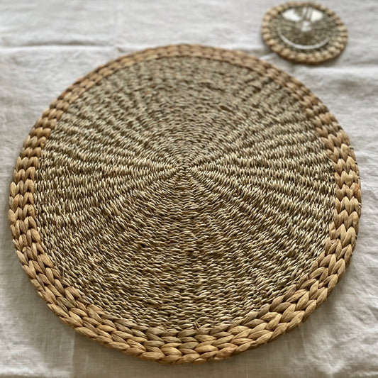 Handmade seagrass and water hyacinth placemats. Styled on a white linen tablecloth.