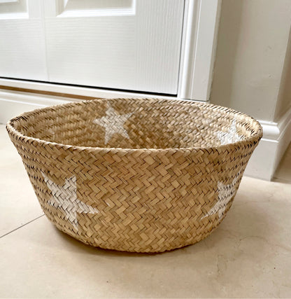 Handmade star detailed seagrass basket with natural woven texture.
