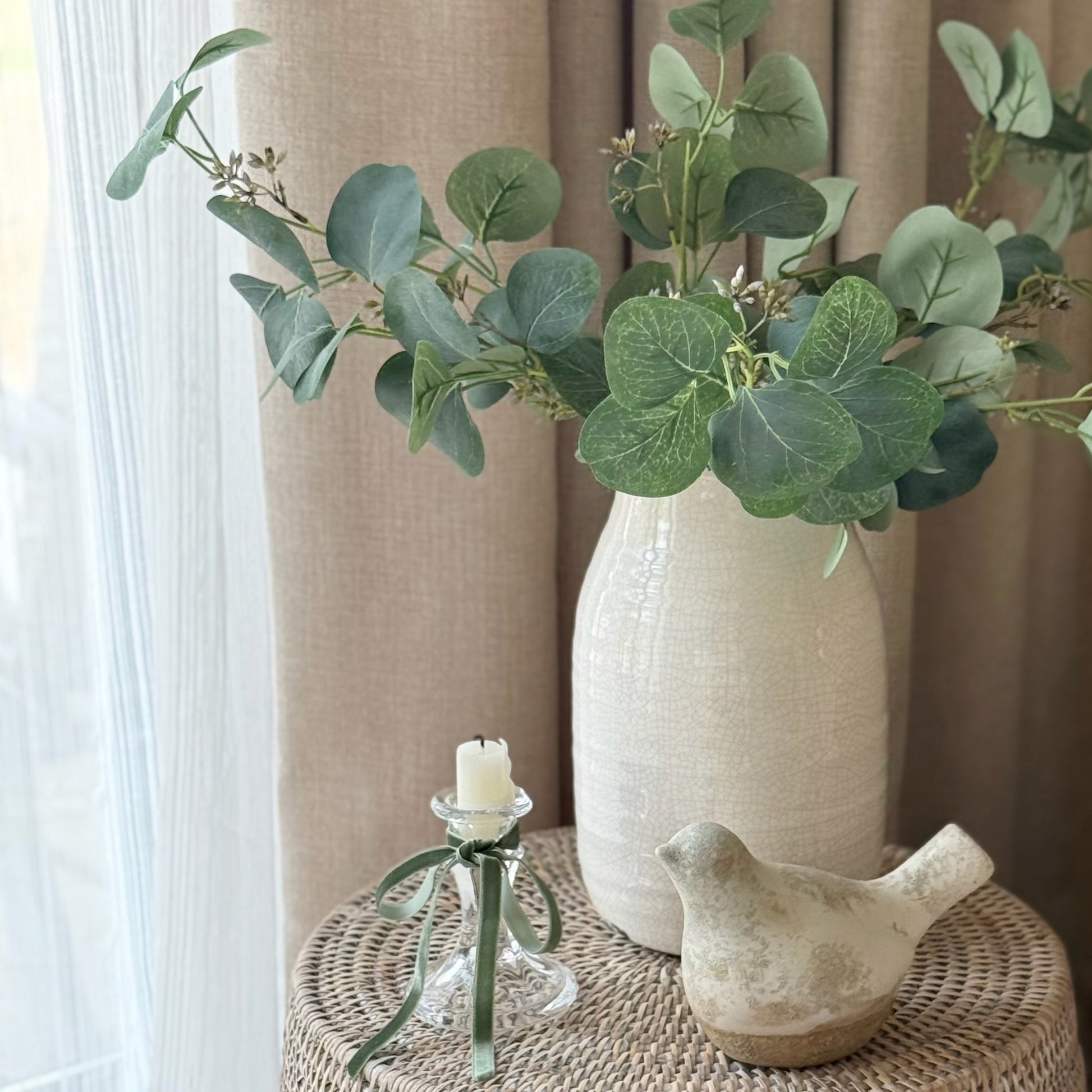 Faux eucalyptus spray with soft green leaves and delicate berries, styled in a vase for a calm, timeless look.