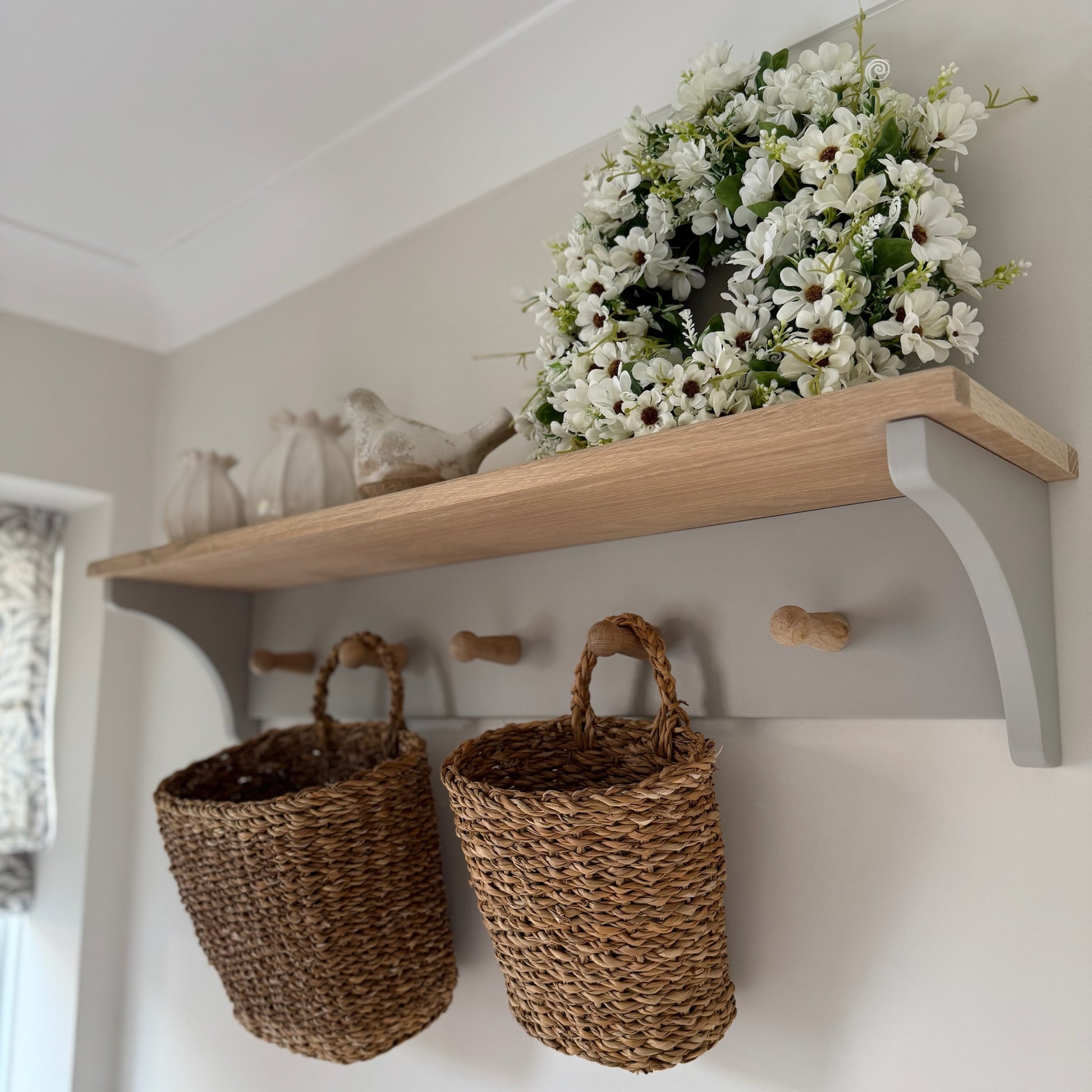 Handcrafted seagrass baskets bringing warmth and texture to a hallway or kitchen, ideal for holding flowers or household items.