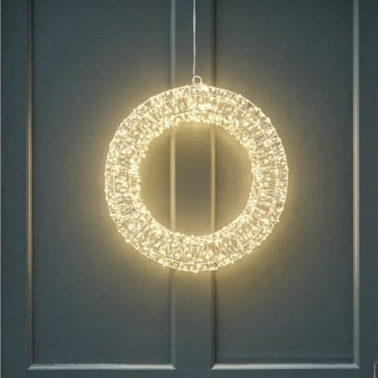 Statement Christmas LED wreath with gentle shimmer effect. Styled on a grey front door.