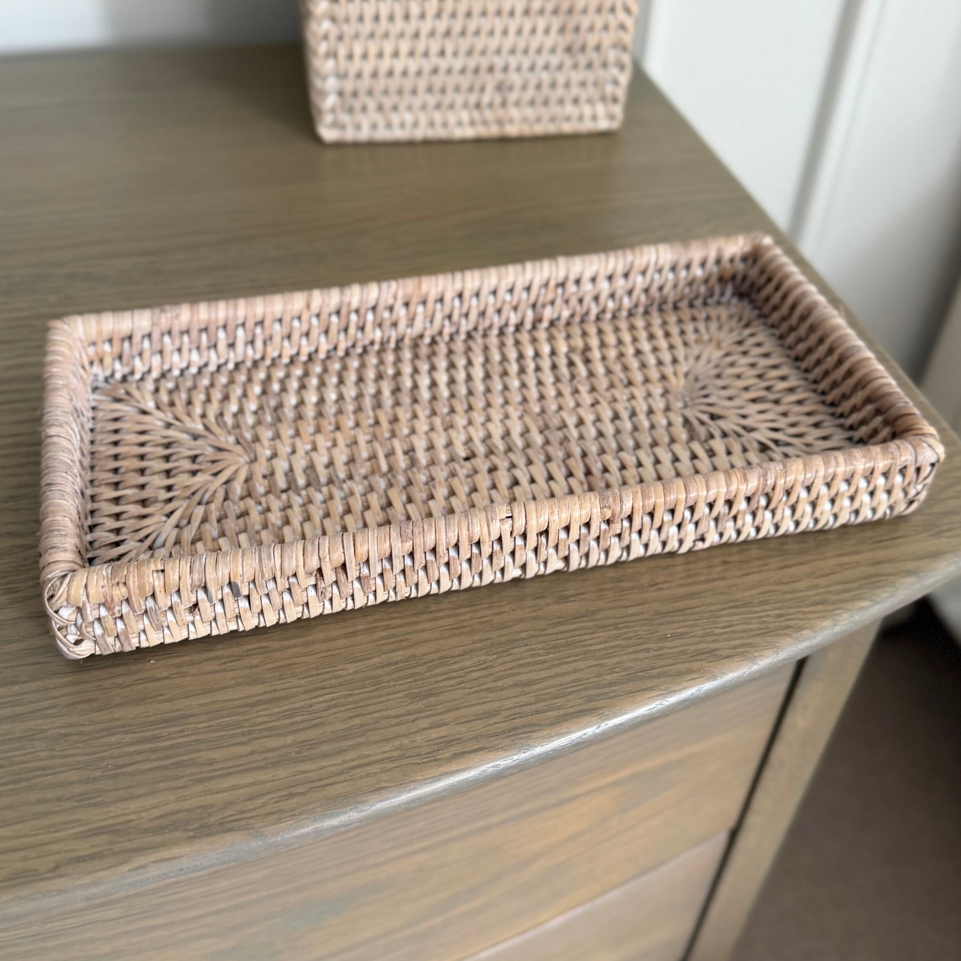 Neutral rattan serving tray crafted from natural materials for timeless, versatile styling.