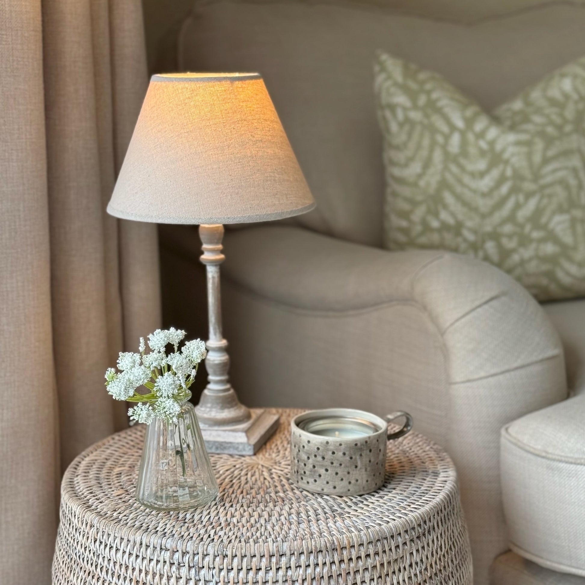 Minimalist small lamp with neutral linen shade, perfect for creating a relaxed, warm ambiance on shelves or sideboards.