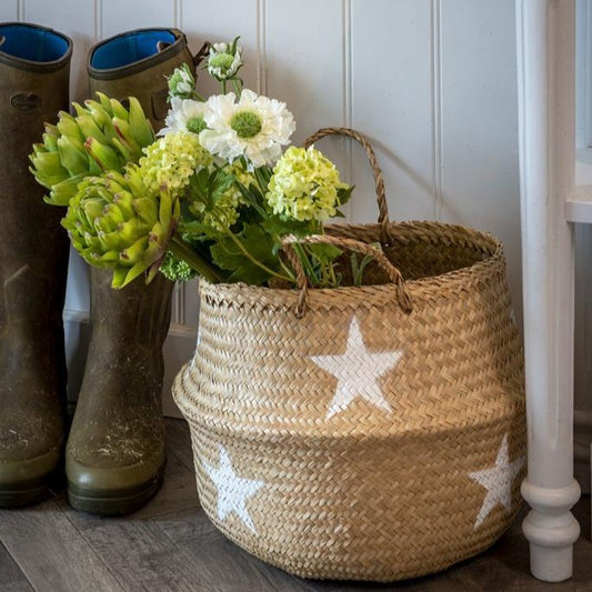 Handmade star detailed seagrass basket with natural woven texture and handles, styled in a hallway with wellies.