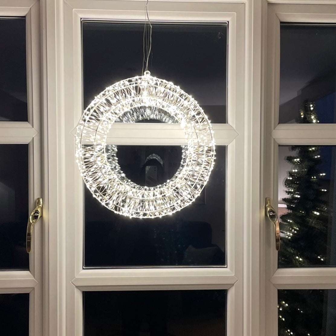Statement Christmas LED wreath with gentle shimmer effect. Styled on a cottage window.