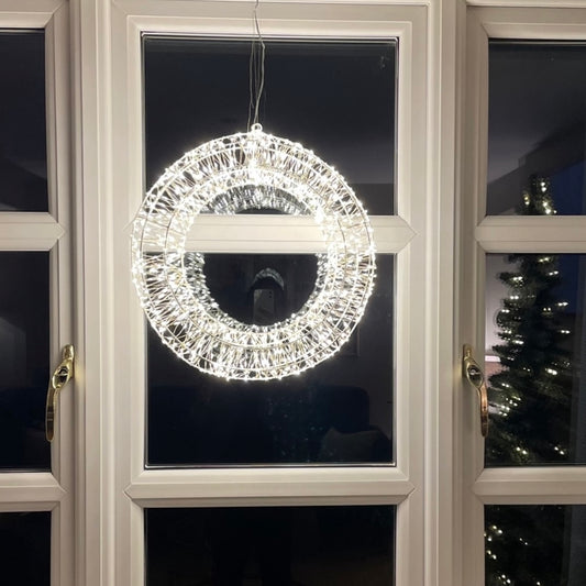 Statement Christmas LED wreath with gentle shimmer effect. Styled on a cottage window.