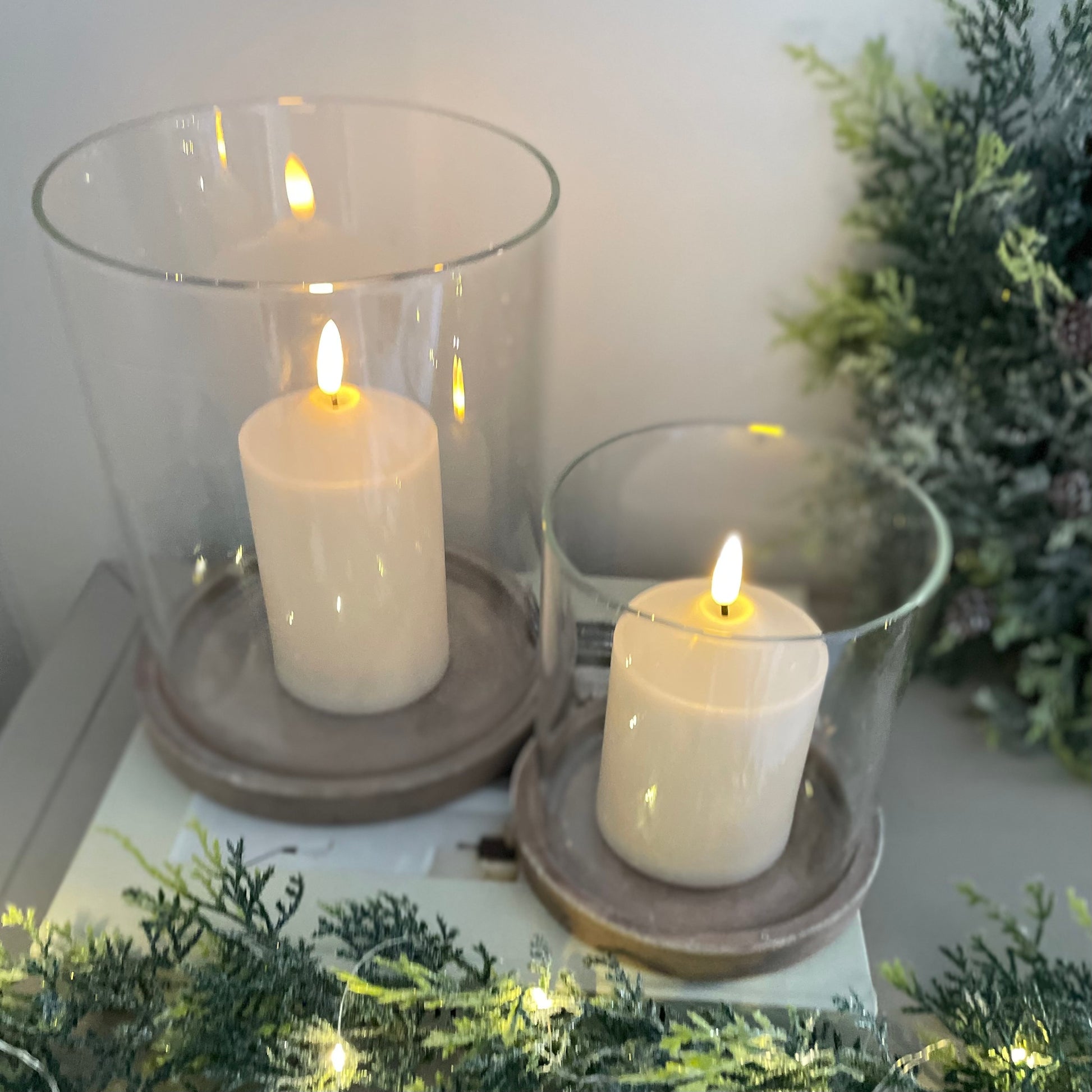 Sienna hurricane with earthy base and glass shade styled on a wooden console table.