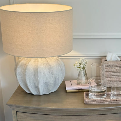 Handcrafted Darcy fluted lamp with rustic finish, adding warm light and texture to a bedside table or cosy corner.