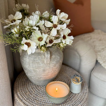 Stone vase with four handles and a weathered finish, styled with dried flowers for an elegant, rustic statement.
