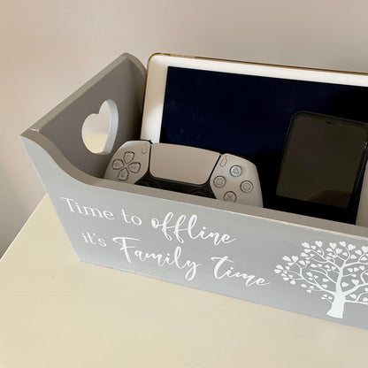 Gray time to offline crate/organiser with tablet, phone, and gaming controller on a light surface.