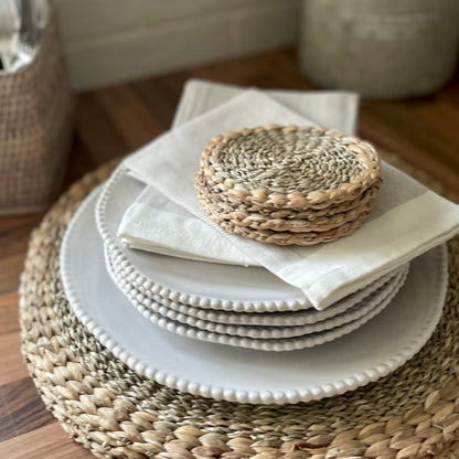 Handmade seagrass and water hyacinth coasters. Styled on dining plates and matching placemats.