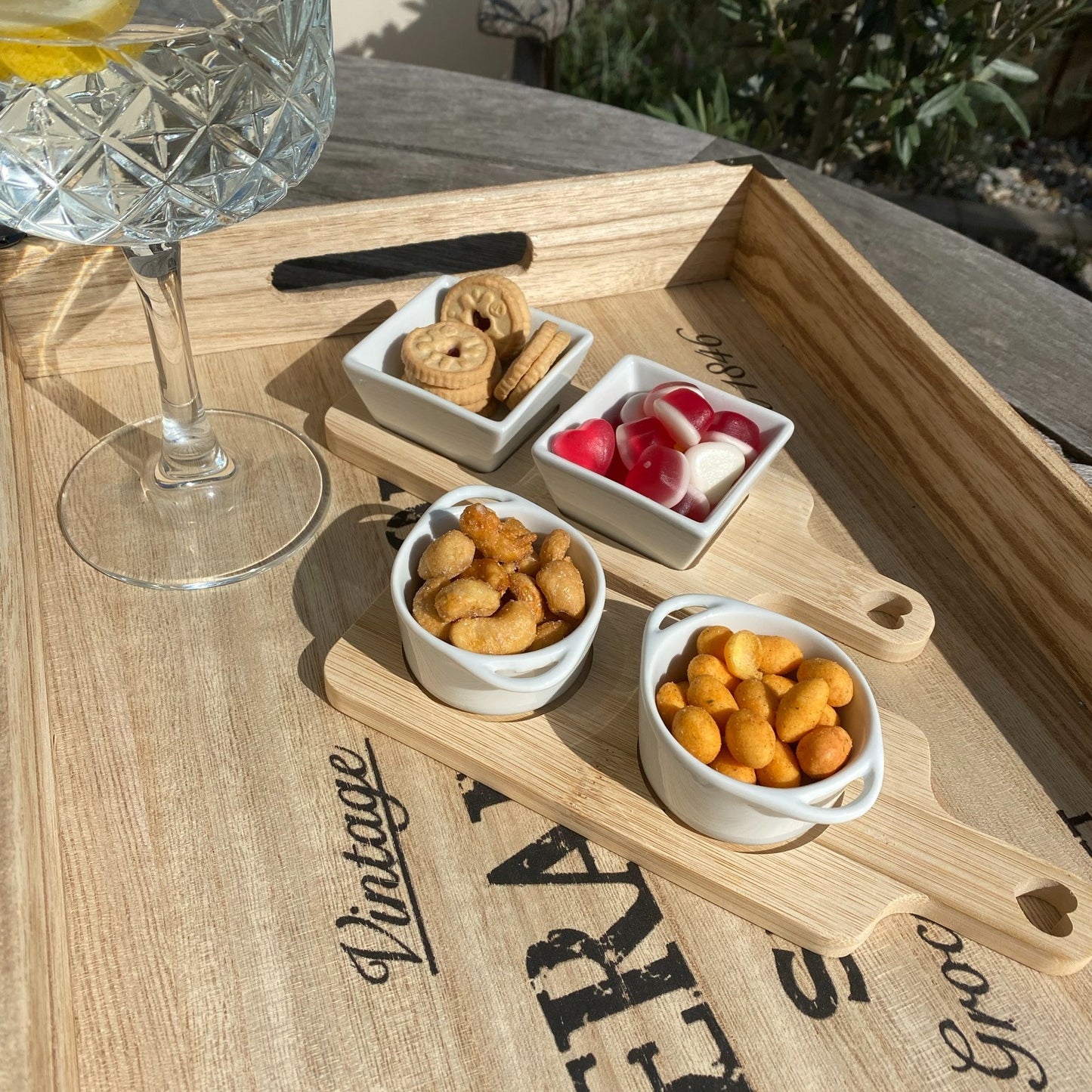 Bamboo serving board set with white dishes, ideal for home entertaining and stylish presentation.