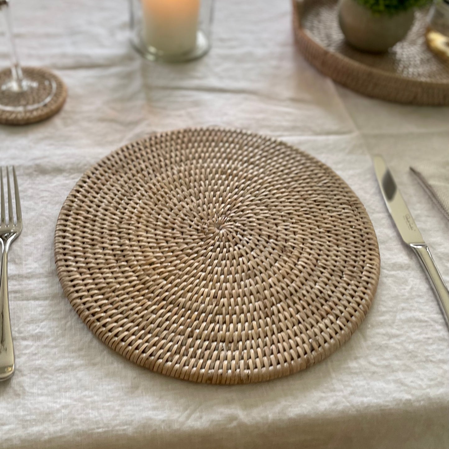 Natural rattan placemats for casual and formal dining. Styled on a white linen tablecloth.