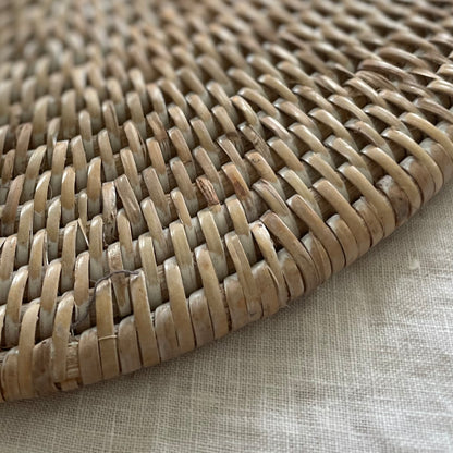 Close up of woven whitewashed rattan placemat texture.