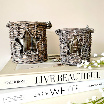 Woven wicker candle holder with star cut-out and glass insert, styled with a tea light candle.