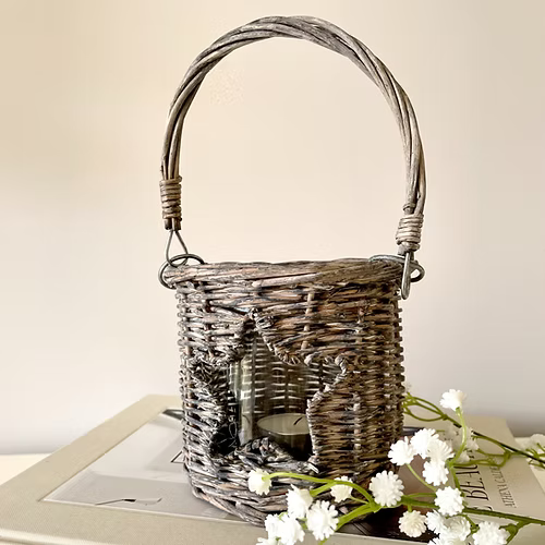 Star shaped cut out wicker candle holder with glass insert, available in two sizes, adding country charm to a room.